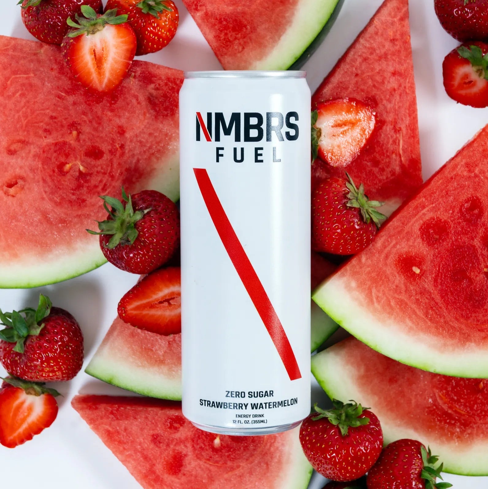 NMBRS Fuel can surrounded by watermelon slices and strawberries on a white background
