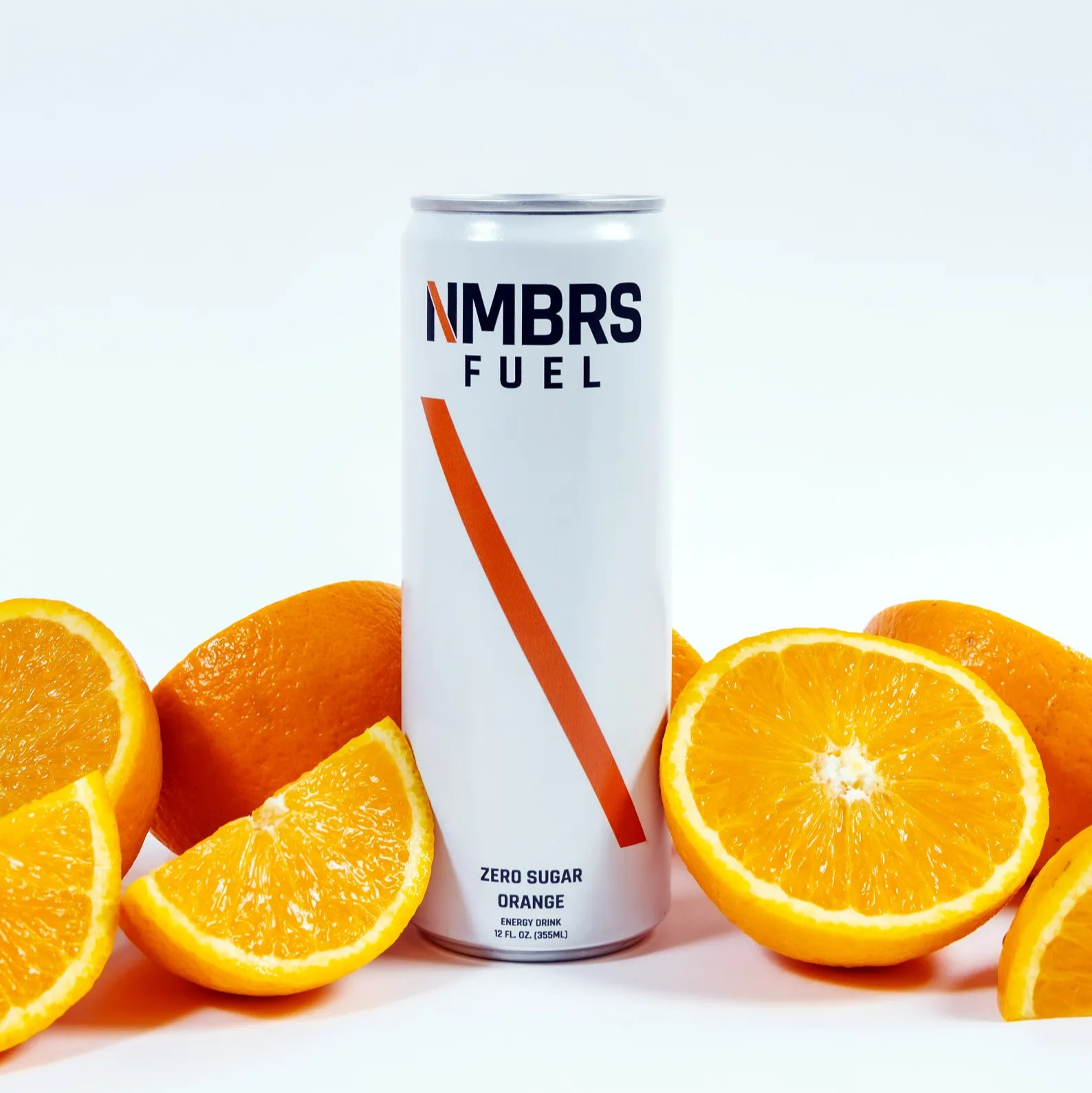 Can of Nimbs Fuel surrounded by sliced oranges on a white background