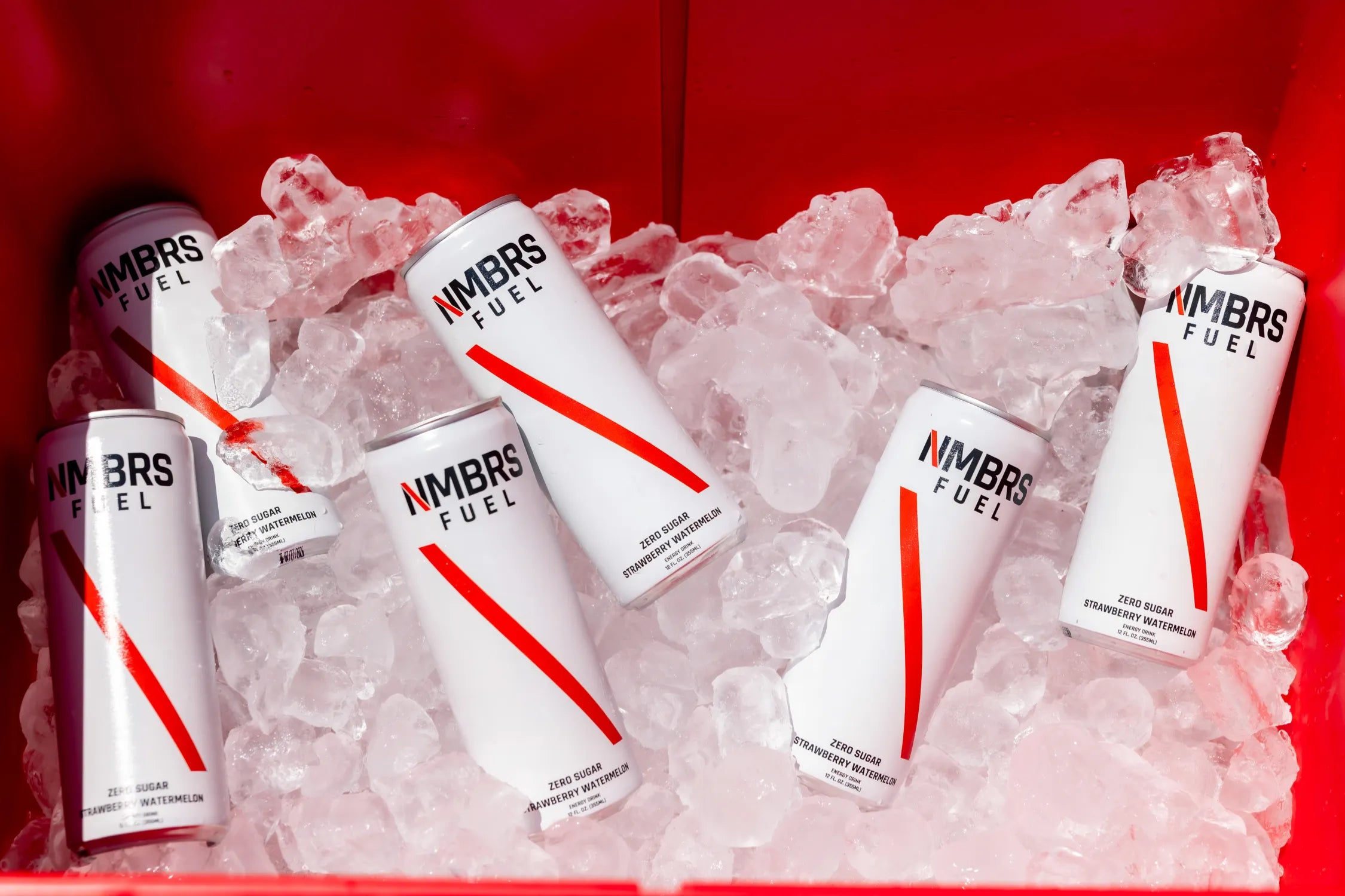 NMBRS Fuel energy drinks on ice with a red background